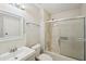 Cozy bathroom with a shower-tub combo, sliding glass door, and white tiled walls and floors at 2988 Chipmunk Se Trl, Marietta, GA 30067