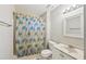 Bright bathroom with a shower-tub combo, colorful curtain, and vanity at 2988 Chipmunk Se Trl, Marietta, GA 30067