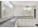 Bathroom featuring a double vanity, granite countertops, and a large mirror at 2988 Chipmunk Se Trl, Marietta, GA 30067