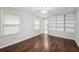 Bedroom features hardwood flooring, large windows, and built-in shelving, complemented by a ceiling fan at 2988 Chipmunk Se Trl, Marietta, GA 30067