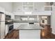Well-appointed kitchen features granite countertops, stainless appliances, a center island and hardwood flooring at 2988 Chipmunk Se Trl, Marietta, GA 30067