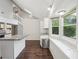 Bright kitchen features granite counters, white cabinets, stainless appliances, and wood-look floors at 2988 Chipmunk Se Trl, Marietta, GA 30067