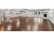 Spacious open living room with hardwood floors, fireplace, and a view of the kitchen and backyard at 2988 Chipmunk Se Trl, Marietta, GA 30067