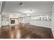 Large living room with hardwood floors, fireplace, and a bar, perfect for entertaining guests at 2988 Chipmunk Se Trl, Marietta, GA 30067