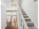 Inviting staircase with wood floors and white banister leading to the upper level at 2988 Chipmunk Se Trl, Marietta, GA 30067