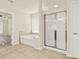 Bright bathroom features a walk-in shower, soaking tub, and tile floors at 625 Lorimore Pass, Canton, GA 30115