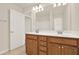 Bathroom boasts a double vanity with warm wood cabinetry at 625 Lorimore Pass, Canton, GA 30115