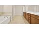 Primary bathroom offers dual sinks, soaking tub and large tile flooring at 625 Lorimore Pass, Canton, GA 30115