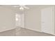 A view of a bedroom featuring carpet with plastic covering, ceiling fan and two doors at 625 Lorimore Pass, Canton, GA 30115