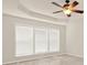 Bright bedroom with tray ceiling and ceiling fan complimented by a large window at 625 Lorimore Pass, Canton, GA 30115