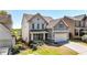 Two-story home with a two-car garage and manicured front lawn on a sunny day at 625 Lorimore Pass, Canton, GA 30115