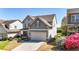 Two-story home with gray vinyl siding, landscaped yard, and attached two-car garage at 625 Lorimore Pass, Canton, GA 30115