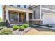 A two-story house with stone accents and a landscaped front yard with a green lawn at 625 Lorimore Pass, Canton, GA 30115