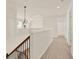 Upstairs hallway features decorative lighting, railing, and access to multiple rooms and bathrooms at 625 Lorimore Pass, Canton, GA 30115