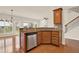 Open concept kitchen with wood cabinets, granite countertops, and stainless steel dishwasher at 625 Lorimore Pass, Canton, GA 30115