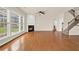 Bright living room featuring a fireplace, large windows, and hardwood flooring at 625 Lorimore Pass, Canton, GA 30115