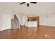 Open-concept living room with hardwood floors, staircase, and natural light near the kitchen at 625 Lorimore Pass, Canton, GA 30115