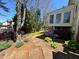 The backyard has lovely stone landscaping with lush greenery and stone steps at 680 Estate Club Cir, Roswell, GA 30075