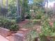 An outdoor space with lush flowerbeds, mature trees, and manicured landscaping at 863 Fairwood Pointe Nw, Acworth, GA 30101