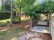A serene backyard with a charming wooden swing and lush greenery for relaxation at 863 Fairwood Pointe Nw, Acworth, GA 30101