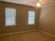 Carpeted bedroom with two windows and ceiling fan at 863 Fairwood Pointe Nw, Acworth, GA 30101