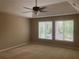 Spacious bedroom with carpet flooring, ceiling fan, and natural light from two windows at 863 Fairwood Pointe Nw, Acworth, GA 30101