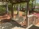 A delightful backyard porch swing with a wooden frame and a view of the garden at 863 Fairwood Pointe Nw, Acworth, GA 30101