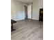 Bright bedroom featuring wood-look floors, neutral paint, and a door leading to other areas of the home at 1504 Augusta Se Dr, Marietta, GA 30067