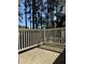 Exterior deck with wood floor, white railing, and tall trees at 1504 Augusta Se Dr, Marietta, GA 30067