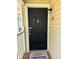 Charming front door with 'Welcome' mat, white trim, and exterior light fixture at 1504 Augusta Se Dr, Marietta, GA 30067