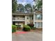 Inviting two-story condo with a balcony, landscaped entrance, and ample parking space at 1504 Augusta Se Dr, Marietta, GA 30067