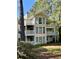 Rear exterior view of a two-story home featuring multiple balconies and lush greenery at 1504 Augusta Se Dr, Marietta, GA 30067
