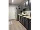 Galley kitchen with stainless steel appliances, shaker cabinets, laminate floors, and neutral paint at 1504 Augusta Se Dr, Marietta, GA 30067