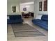 Open-concept living room with neutral paint, two blue sofas, a rug, and wood floors at 1504 Augusta Se Dr, Marietta, GA 30067