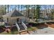 Exterior view of community pool and pool house surrounded by lush landscaping and mature trees at 1504 Augusta Se Dr, Marietta, GA 30067
