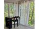 Bright sunroom with large windows, neutral walls, wood floors, a desk, and a chair at 1504 Augusta Se Dr, Marietta, GA 30067
