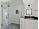 Bathroom featuring a glass shower with herringbone tile and a vanity with a black countertop at 1728 Line St, Decatur, GA 30032