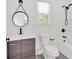 Bathroom showcasing a white vanity with a black faucet and a modern mirror with black trim at 1728 Line St, Decatur, GA 30032