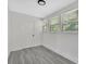 Bedroom featuring three windows providing ample light, gray floors, and white walls at 1728 Line St, Decatur, GA 30032