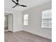 Bedroom with grey floors, white walls, ceiling fan, and two windows at 1728 Line St, Decatur, GA 30032