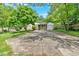 Charming single-story home featuring a covered porch and a spacious driveway, surrounded by mature trees and lush greenery at 1728 Line St, Decatur, GA 30032