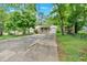 Charming single-story home featuring a covered porch and a spacious driveway, surrounded by mature trees and lush greenery at 1728 Line St, Decatur, GA 30032