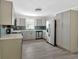 Modern kitchen with stainless steel appliances, sleek gray cabinets, quartz countertops, and stylish backsplash at 1728 Line St, Decatur, GA 30032