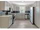 Updated kitchen featuring stainless steel appliances, sleek gray cabinets, quartz countertops, and stylish backsplash at 1728 Line St, Decatur, GA 30032