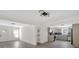 Spacious living room with modern light fixture that flows into the kitchen with gray cabinets and stainless steel appliances at 1728 Line St, Decatur, GA 30032