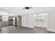 Bright open-concept living area flows into the renovated kitchen featuring stainless steel appliances and gray cabinetry at 1728 Line St, Decatur, GA 30032