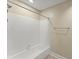 This bathroom features white tiled walls and shower and a mounted towel rack at 208 Bainbridge Dr, Atlanta, GA 30327