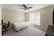 This carpeted bedroom features a ceiling fan, desk, bed and window at 208 Bainbridge Dr, Atlanta, GA 30327