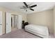 This carpeted bedroom features a ceiling fan, desk, bed and attached bathroom at 208 Bainbridge Dr, Atlanta, GA 30327
