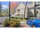 Two-story condo with balcony, framed by mature trees and meticulous landscaping at 208 Bainbridge Dr, Atlanta, GA 30327